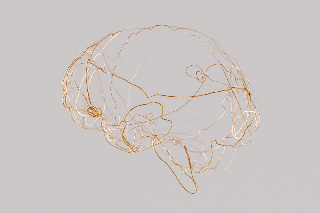 a wire brain with light coming out of it